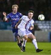 22 January 2024; Warren Davis of Drogheda United in action against Finn Cowper Gray of Bohemians during the PTSB Leinster Senior Cup Group A match between Drogheda United and Bohemians at Weaver's Park in Drogheda, Louth. Photo by Ben McShane/Sportsfile
