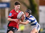 25 January 2024; Aiden McLoughlin of CUS is tackled by Conor Kehoe of Good Counsel, New Ross, during the Bank of Ireland Leinster Rugby Schools Father Godfrey Cup semi-final match between Good Counsel, New Ross and CUS at Energia Park in Dublin. Photo by Ben McShane/Sportsfile