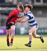 25 January 2024; Peter Smyth of CUS is tackled by Lee Whitty of Good Counsel, New Ross, during the Bank of Ireland Leinster Rugby Schools Father Godfrey Cup semi-final match between Good Counsel, New Ross and CUS at Energia Park in Dublin. Photo by Ben McShane/Sportsfile