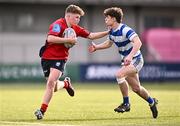 25 January 2024; Peter Smyth of CUS is tackled by Lee Whitty of Good Counsel, New Ross, during the Bank of Ireland Leinster Rugby Schools Father Godfrey Cup semi-final match between Good Counsel, New Ross and CUS at Energia Park in Dublin. Photo by Ben McShane/Sportsfile