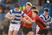25 January 2024; James McDonald of Good Counsel, New Ross, is tackled by Lachlan Honan of CUS during the Bank of Ireland Leinster Rugby Schools Father Godfrey Cup semi-final match between Good Counsel, New Ross and CUS at Energia Park in Dublin. Photo by Ben McShane/Sportsfile