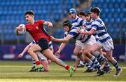 25 January 2024; David Li of CUS makes a break despite the tackle of James McDonald of Good Counsel, New Ross, during the Bank of Ireland Leinster Rugby Schools Father Godfrey Cup semi-final match between Good Counsel, New Ross and CUS at Energia Park in Dublin. Photo by Ben McShane/Sportsfile