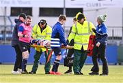 25 January 2024; Philip Murphy of Good Counsel, New Ross, is assisted off the pitch by medical personnel during the Bank of Ireland Leinster Rugby Schools Father Godfrey Cup semi-final match between Good Counsel, New Ross and CUS at Energia Park in Dublin. Photo by Ben McShane/Sportsfile