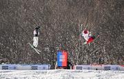 27 January 2024; Thomas Dooley of Team Ireland, left, and Bradey Koehler of Canada competing in the mens dual moguls event during day eight of the Winter Youth Olympic Games 2024 at Gangwon in South Korea. Photo by Eóin Noonan/Sportsfile