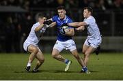 27 January 2024; Dara McVeety of Cavan in action against Jack Sargent, left, and Jimmy Hyland of Kildare during the Allianz Football League Division 2 match between Kildare and Cavan at Netwatch Cullen Park in Carlow. Photo by David Fitzgerald/Sportsfile
