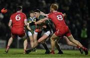 27 January 2024; Sean O'Shea of Kerry in action against Derry players Gareth McKinless, Padraig McGrogan and Conor Glass during the Allianz Football League Division 1 match between Kerry and Derry at Austin Stack Park in Tralee, Kerry. Photo by Brendan Moran/Sportsfile