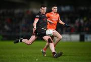 27 January 2024; Tommy Durnin of Louth kicks a point despite the attention of Greg McCabe of Armagh during the Allianz Football League Division 2 match between Armagh and Louth at BOX-IT Athletic Grounds in Armagh. Photo by Ben McShane/Sportsfile