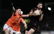 27 January 2024; Dermot Campbell of Louth is tackled by Oisín Conaty of Armagh during the Allianz Football League Division 2 match between Armagh and Louth at BOX-IT Athletic Grounds in Armagh. Photo by Ben McShane/Sportsfile