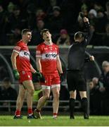 27 January 2024; Ciaran McFaul of Derry, left, is shown a black card by referee Joe McQuillan during the Allianz Football League Division 1 match between Kerry and Derry at Austin Stack Park in Tralee, Kerry. Photo by Brendan Moran/Sportsfile
