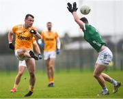 28 January 2024; Dermot McAleese of Antrim scores a point despite the efforts of Paul Maher of Limerick during the Allianz Football League Division 3 match between Limerick and Antrim at Mick Neville Park in Rathkeale, Limerick. Photo by Tom Beary/Sportsfile