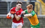 28 January 2024; Chris Og Jones of Cork in action against Ciarán Moore of Donegal during the Allianz Football League Division 2 match between Donegal and Cork at MacCumhaill Park in Ballybofey, Donegal. Photo by Ramsey Cardy/Sportsfile