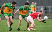 28 January 2024; Matty Taylor of Cork in action against Caolan McGonagle, left, and Domhnall Mac Giolla Bhride of Donegal during the Allianz Football League Division 2 match between Donegal and Cork at MacCumhaill Park in Ballybofey, Donegal. Photo by Ramsey Cardy/Sportsfile