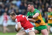 28 January 2024; Matty Taylor of Cork in action against Patrick McBrearty of Donegal during the Allianz Football League Division 2 match between Donegal and Cork at MacCumhaill Park in Ballybofey, Donegal. Photo by Ramsey Cardy/Sportsfile