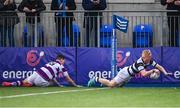 28 January 2024; Gordon Barr of Belvedere College dives over to score his side's third try despite the efforts of Gavin Keane of Clongowes Wood College during the Bank of Ireland Leinster Schools Senior Cup First Round match between Clongowes Wood College and Belvedere College at Energia Park in Dublin. Photo by Tyler Miller/Sportsfile