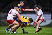 28 January 2024; David Murray of Roscommon, supported by teammate Eoin McCormack, left, is tackled by Conall Devlin of Tyrone, supported by teammate Tarlach Quinn, right, during the Allianz Football League Division 1 match between Tyrone and Roscommon at O’Neills Healy Park in Omagh, Tyrone. Photo by Ben McShane/Sportsfile