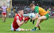 28 January 2024; Rory Maguire of Cork in action against Ciaran Moore of Donegal during the Allianz Football League Division 2 match between Donegal and Cork at MacCumhaill Park in Ballybofey, Donegal. Photo by Ramsey Cardy/Sportsfile