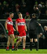 27 January 2024; Ciaran McFaul of Derry, left, is shown a black card by referee Joe McQuillan during the Allianz Football League Division 1 match between Kerry and Derry at Austin Stack Park in Tralee, Kerry. Photo by Brendan Moran/Sportsfile