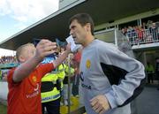 17 July 2004; Roy Keane, Manchester United XI, with a Manchester United fan before the start of the game. Friendly game, Cobh Ramblers v Manchester United XI, Turners Cross, Cork. Picture credit; Matt Browne / SPORTSFILE
