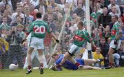 18 July 2004; Mayo's Austin O'Malley scores his sides second goal, watched by team-mates Declan Sweeney, (20) and Trevor Mortimer, despite the efforts of Roscommon goalkeeper Shane Curran. Bank of Ireland Connacht Senior Football Championship Final, Mayo v Roscommon, McHale Park, Castlebar, Co. Mayo. Picture credit; Damien Eagers / SPORTSFILE