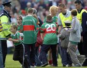 18 July 2004; Mayo supporters invade the pitch early to congradulate Mayo's Conor Mortimer as Gardai and stewarts try to clear the pitch. Bank of Ireland Connacht Senior Football Championship Final, Mayo v Roscommon, McHale Park, Castlebar, Co. Mayo. Picture credit; Damien Eagers / SPORTSFILE