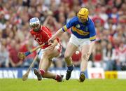 10 July 2004; Eamon Corcoran, Tipperary, in action against Garvan McCarthy, Cork. Guinness Senior Hurling Championship Qualifier, Round 3, Cork v Tipperary, Fitzgerald Stadium, Killarney, Co. Kerry. Picture credit; Brendan Moran / SPORTSFILE