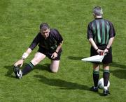 18 July 2004; Referee Pat McEnaney stretches before the game while chatting with linesman Paul Finnegan, right. Bank of Ireland Leinster Senior Football Championship Final, Laois v Westmeath, Croke Park, Dublin. Picture credit; Ray McManus / SPORTSFILE