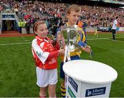 8 September 2013; Rebecca Barry, Gaelscoil An Ghoirt Alainn, Cork, and Eoghan Foudy, Ennis CBS Primary Schools, bring out the Liam MacCarthy Cup ahead of the game. GAA Hurling All-Ireland Senior Championship Final, Cork v Clare, Croke Park, Dublin. Picture credit: Stephen McCarthy / SPORTSFILE