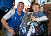 9 September 2013; Keenan Fitzpatrick, age 8, from Gorey, Co. Wexford, holds the Irish Press Cup with Waterford manager Seán Power on a visit by the All-Ireland Minor Hurling Champions to Our Lady's Hospital for Sick Children, Crumlin. Picture credit: Barry Cregg / SPORTSFILE
