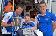 9 September 2013; Waterford captain Kevin Daly, left, and Patrick Curran, with Sean Bergin, age 11, from Roscrea, Co. Tipperary, and the Irish Press Cup on a visit by the All-Ireland Minor Hurling Champions to Our Lady's Hospital for Sick Children, Crumlin. Picture credit: Barry Cregg / SPORTSFILE