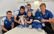 9 September 2013; Waterford's Patrick Curran, left, Kevin Daly, Shane Bennett and Tom Devine with Morgan McCann, age 5, from Tallaght, Co. Dublin, and the Irish Press Cup on a visit by the All-Ireland Minor Hurling Champions to Our Lady's Hospital for Sick Children, Crumlin. Picture credit: Barry Cregg / SPORTSFILE