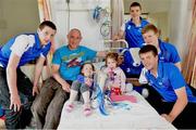 9 September 2013; Eamonn Brady with his daughters Lilly, left, and Emily both aged 3, and the Irish Press cup with Waterford players from left, Shane Bennett, Patrick Curran, Tom Devine and Kevin Daly on a visit by the All-Ireland Minor Hurling Champions to Our Lady's Hospital for Sick Children, Crumlin. Picture credit: Barry Cregg / SPORTSFILE