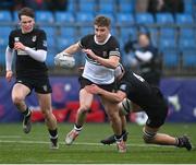 31 January 2024; Paddy Taylor of Newbridge College is tackled by Joe Finn of Cistercian College Roscrea during the Bank of Ireland Leinster Schools Senior Cup First Round match between Newbridge College and Cistercian College Roscrea at Energia Park in Dublin. Photo by David Fitzgerald/Sportsfile