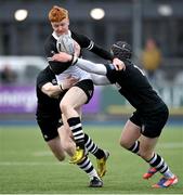 31 January 2024; Dara Cosgrave of Newbridge College is tackled by Dan Punch, right, and Robert Carney of Cistercian College Roscrea during the Bank of Ireland Leinster Schools Senior Cup First Round match between Newbridge College and Cistercian College Roscrea at Energia Park in Dublin. Photo by David Fitzgerald/Sportsfile