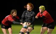 31 January 2024; Isobel O'Sullivan of Metro in action against Shayla Hollywood, left, and Chloe Ericson of North East during the BearingPoint Sarah Robinson Cup round four match between North East and Metro at Skerries RFC in Skerries, Dublin. Photo by Sam Barnes/Sportsfile
