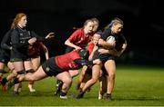 31 January 2024; Leah Nelson of Metro is tackled by Lauren Bryce and Mia Coan of North East during the BearingPoint Sarah Robinson Cup round four match between North East and Metro at Skerries RFC in Skerries, Dublin. Photo by Sam Barnes/Sportsfile