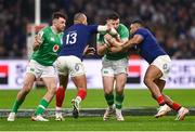 2 February 2024; Robbie Henshaw of Ireland is tackled by Gael Fickou, left, and Jonathan Danty of France during the Guinness Six Nations Rugby Championship match between France and Ireland at the Stade Velodrome in Marseille, France. Photo by Harry Murphy/Sportsfile