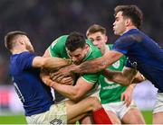 2 February 2024; Robbie Henshaw of Ireland is tackled by Matthieu Jalibert, left, and Damian Penaud of France during the Guinness Six Nations Rugby Championship match between France and Ireland at the Stade Velodrome in Marseille, France. Photo by Ramsey Cardy/Sportsfile