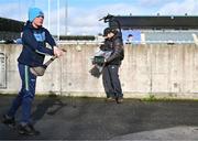 3 February 2024; Dublin supporter Julian Wilkinson, from The Ward, North County Dublin, pucks a ball as he is filmed by a camera operator before the Allianz Hurling League Division 1 Group B match between Dublin and Tipperary at Parnell Park in Dublin. Photo by Tyler Miller/Sportsfile
