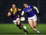 3 February 2024; Evan O'Carroll of Laois in action against Kevin O'Grady of Wexford during the Allianz Football League Division 4 match between Wexford and Laois at Chadwicks Wexford Park in Wexford. Photo by Michael P Ryan/Sportsfile