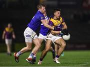 3 February 2024; Eoin Porter of Wexford in action against Mark Timmons of Laois during the Allianz Football League Division 4 match between Wexford and Laois at Chadwicks Wexford Park in Wexford. Photo by Michael P Ryan/Sportsfile