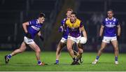 3 February 2024; Liam Coleman of Wexford in action against Laois players from left, Conor Heffernan, James Kelly, and Niall Corbet during the Allianz Football League Division 4 match between Wexford and Laois at Chadwicks Wexford Park in Wexford. Photo by Michael P Ryan/Sportsfile