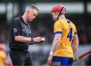 4 February 2024; Referee Paul Faloon takes the name of Paul Flanagan of Clare during the Allianz Hurling League Division 1 Group A match between Clare and Cork at Cusack Park in Ennis, Clare. Photo by Ray McManus/Sportsfile