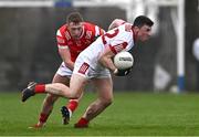 4 February 2024; Mark Cronin of Cork is tackled by Ryan Burns of Louth during the Allianz Football League Division 2 match between Louth and Cork at DEFY Páirc Mhuire in Ardee, Louth. Photo by Ben McShane/Sportsfile