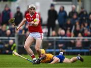 4 February 2024; Tommy O'Connell of Cork slips past Mark Rogers of Clare to score his side's second goal, in the 28th minute, during the Allianz Hurling League Division 1 Group A match between Clare and Cork at Cusack Park in Ennis, Clare. Photo by Ray McManus/Sportsfile