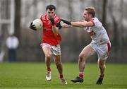 4 February 2024; Craig Lennon of Louth in action against Ruairi Deane of Cork during the Allianz Football League Division 2 match between Louth and Cork at DEFY Páirc Mhuire in Ardee, Louth. Photo by Ben McShane/Sportsfile