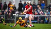 4 February 2024; Tommy O'Connell of Cork slips past Mark Rogers of Clare to score his side's second goal, in the 28th minute, during the Allianz Hurling League Division 1 Group A match between Clare and Cork at Cusack Park in Ennis, Clare. Photo by Ray McManus/Sportsfile