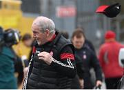 4 February 2024; Derry manager Mickey Harte's cap blows off in the wind on his arrival to the Allianz Football League Division 1 match between Derry and Tyrone at Celtic Park in Derry. Photo by Ramsey Cardy/Sportsfile