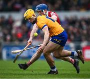 4 February 2024; Mark Rogers of Clare is tackled by Sean O'Donoghue of Cork during the Allianz Hurling League Division 1 Group A match between Clare and Cork at Cusack Park in Ennis, Clare. Photo by Ray McManus/Sportsfile