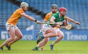 4 February 2024; Donnacha Ó Dálaigh of Limerick is tackled by Paddy Burke, left, and Ryan McGarry of Antrim during the Allianz Hurling League Division 1 Group B match between Limerick and Antrim at FBD Semple Stadium in Thurles, Tipperary. Photo by Tom Beary/Sportsfile