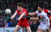 4 February 2024; Ethan Doherty of Derry in action against Padraig Hampsey of Tyrone during the Allianz Football League Division 1 match between Derry and Tyrone at Celtic Park in Derry. Photo by Ramsey Cardy/Sportsfile